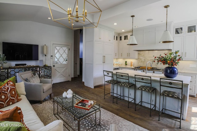 307 Grand Blvd, Greenwood, MS 38930 - living room with recessed lighting, dark wood finished floors, vaulted ceiling, and an inviting chandelier