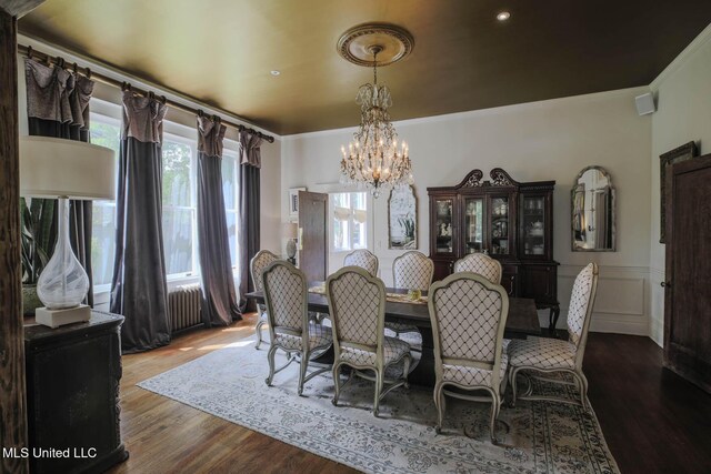 307 Grand Blvd, Greenwood, MS 38930 - dining area featuring radiator, ornamental molding, wood finished floors, and a chandelier