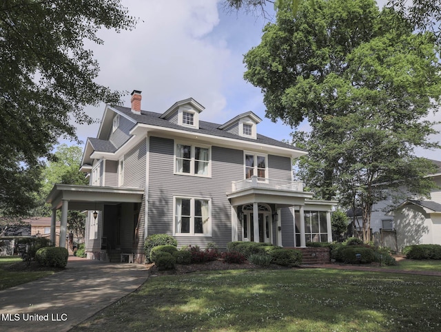 307 Grand Blvd, Greenwood, MS 38930 - view of front of home featuring a sunroom, a front lawn, and a chimney
