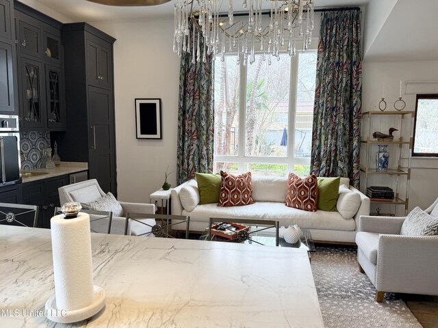 307 Grand Blvd, Greenwood, MS 38930 - living area featuring baseboards and a notable chandelier