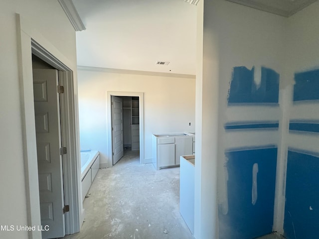 bathroom featuring unfinished concrete flooring, a garden tub, visible vents, and crown molding