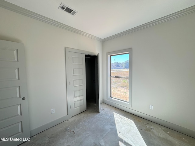 unfurnished bedroom with visible vents, crown molding, and baseboards