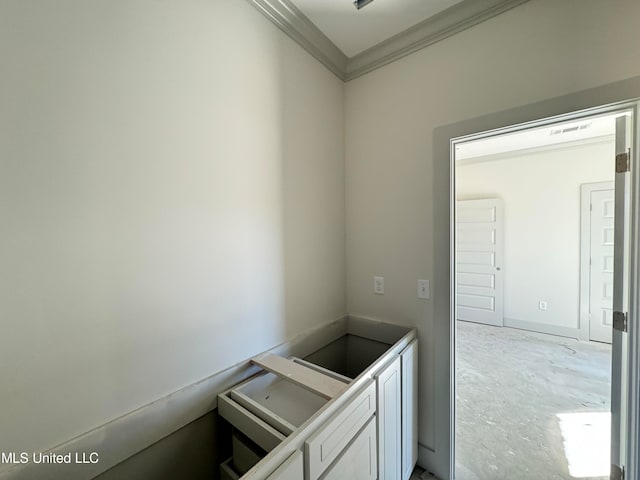 bathroom with unfinished concrete floors, visible vents, and crown molding