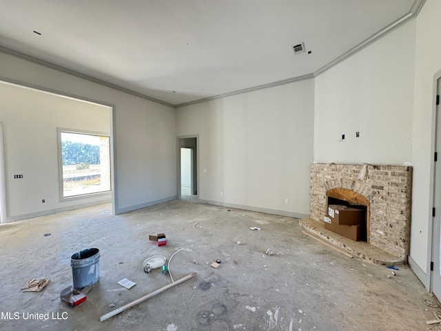 unfurnished living room featuring baseboards, a brick fireplace, visible vents, and crown molding