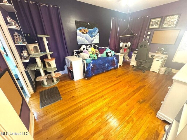 bedroom with visible vents and wood finished floors