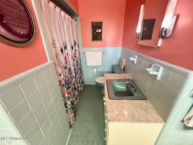 bathroom with tile patterned flooring, toilet, and a shower with shower curtain