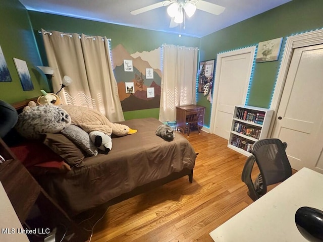 bedroom featuring ceiling fan and wood finished floors