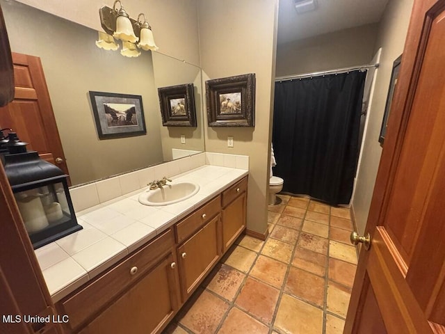 bathroom featuring toilet, vanity, a shower with shower curtain, and a chandelier