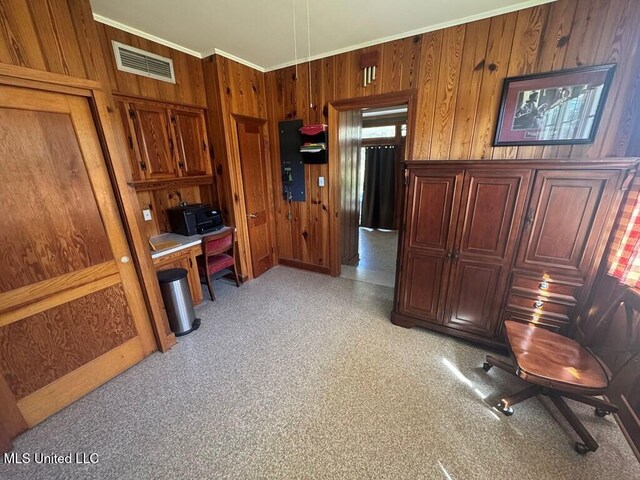 office space featuring visible vents, wood walls, and ornamental molding