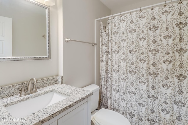 bathroom with vanity, toilet, and a shower with curtain