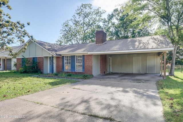 ranch-style house with concrete driveway, a chimney, a front yard, and brick siding