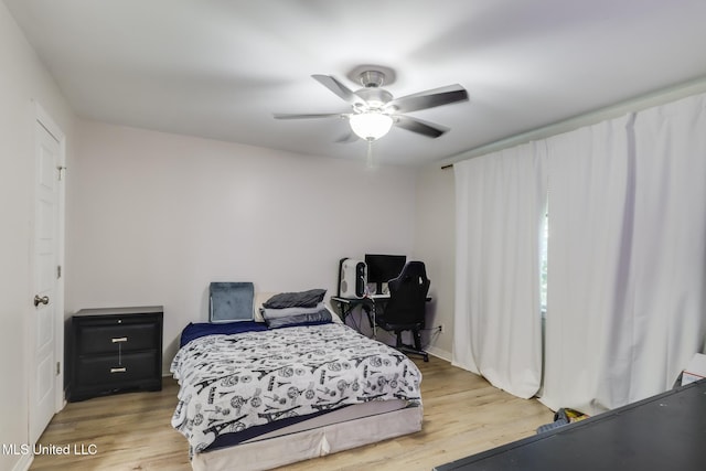 bedroom with a ceiling fan and wood finished floors