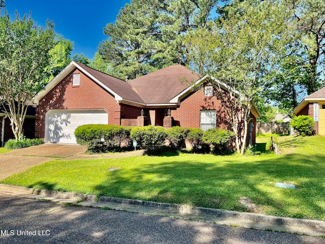 view of front of property featuring a front yard and a garage