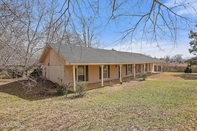 rear view of property with a yard and fence