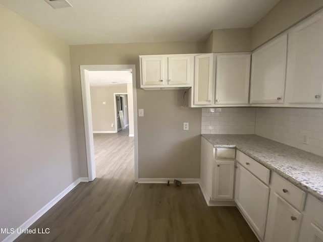 kitchen with backsplash, white cabinets, and dark wood-style flooring