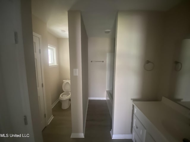 full bath with vanity, toilet, and baseboards