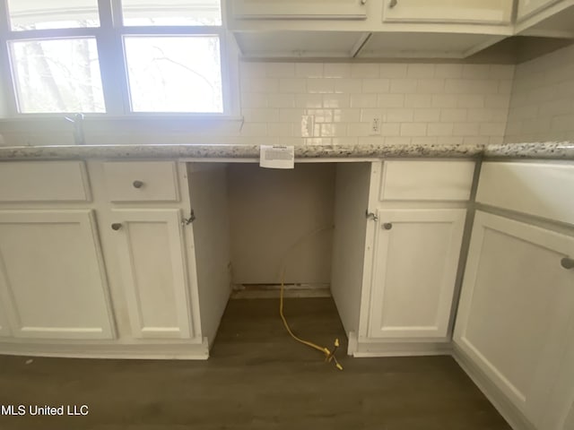 kitchen featuring decorative backsplash, white cabinets, and dark wood-style flooring