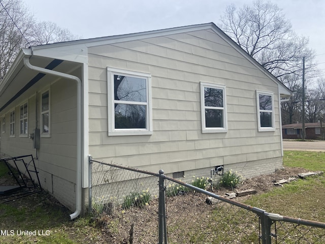 view of property exterior with fence and crawl space