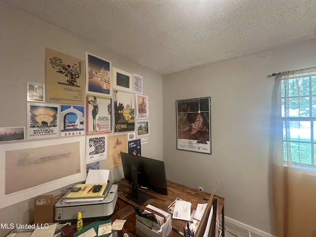 home office featuring a textured ceiling