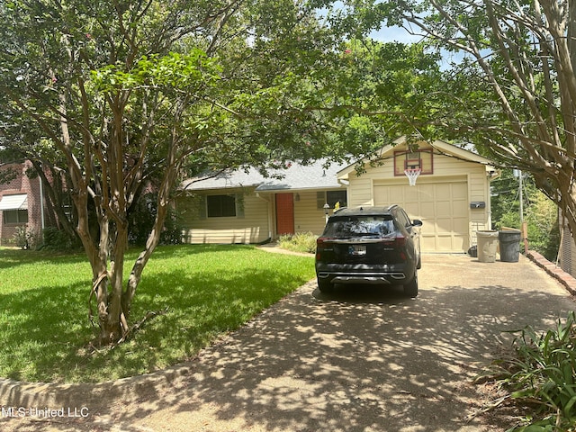 view of front of house with a front yard and a garage