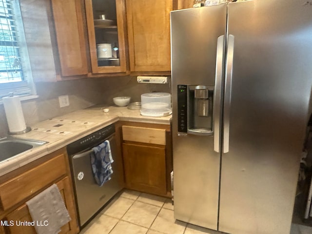 kitchen featuring stainless steel appliances and light tile patterned floors