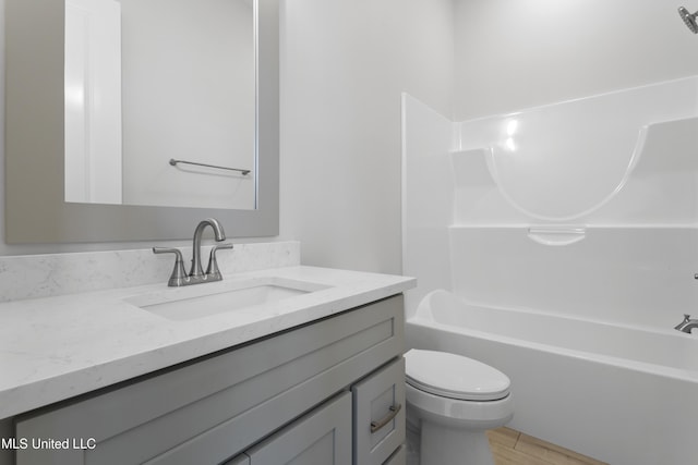 full bathroom with toilet, vanity, and shower / tub combination