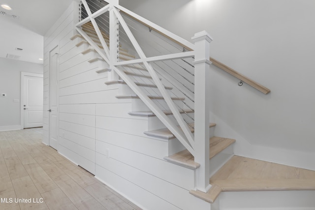 staircase featuring hardwood / wood-style flooring