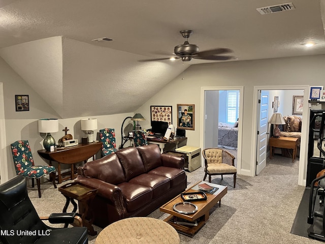 living room featuring light colored carpet, visible vents, ceiling fan, and vaulted ceiling