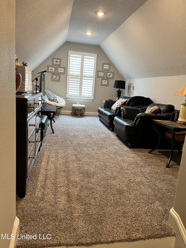 living room with a textured ceiling, vaulted ceiling, carpet, and baseboards