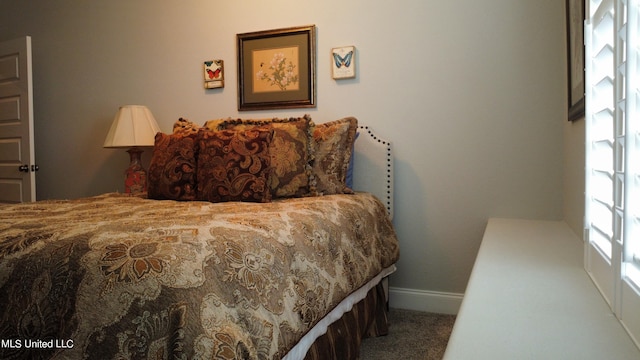 bedroom with baseboards and carpet floors