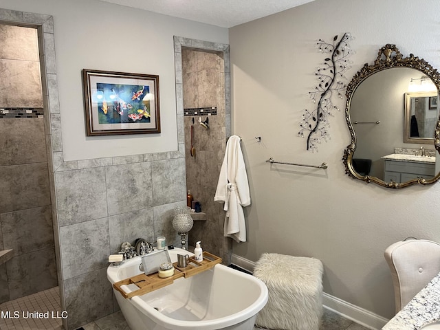 full bathroom with a walk in shower, vanity, a freestanding bath, and tile walls