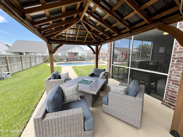 view of patio featuring a fenced in pool, an outdoor living space with a fire pit, a gazebo, and a fenced backyard