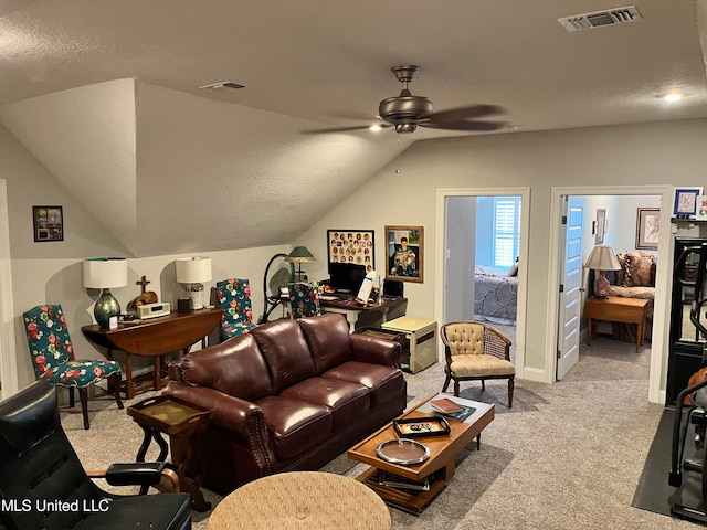 carpeted living room featuring ceiling fan, a textured ceiling, and lofted ceiling