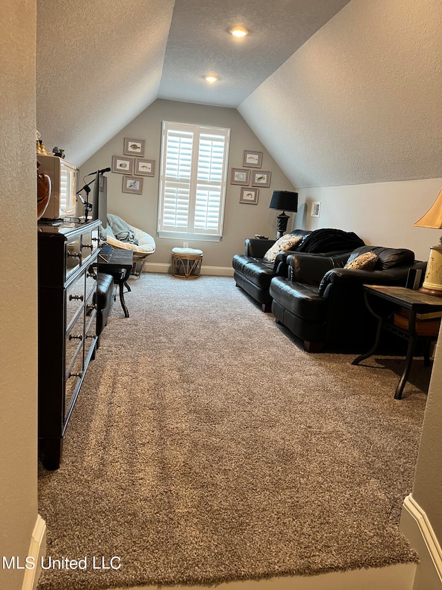 carpeted living room with a textured ceiling and vaulted ceiling