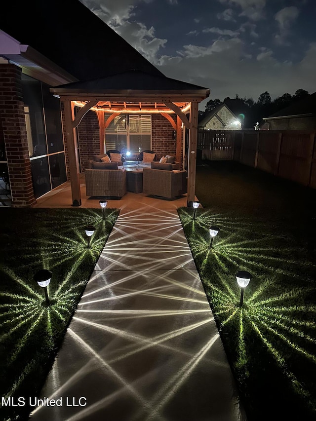 exterior space with fence, a gazebo, and an outdoor living space