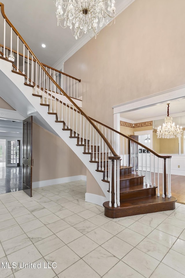 staircase featuring a notable chandelier and ornamental molding