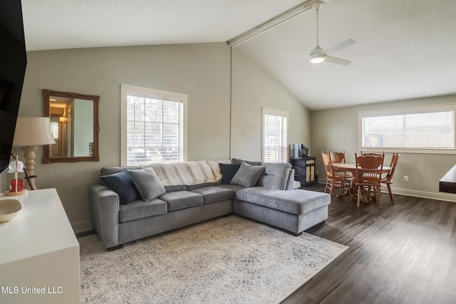 living area featuring baseboards, a ceiling fan, lofted ceiling, and wood finished floors