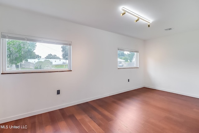 unfurnished room featuring dark wood-type flooring