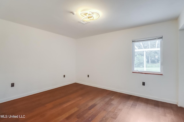 spare room featuring dark hardwood / wood-style flooring