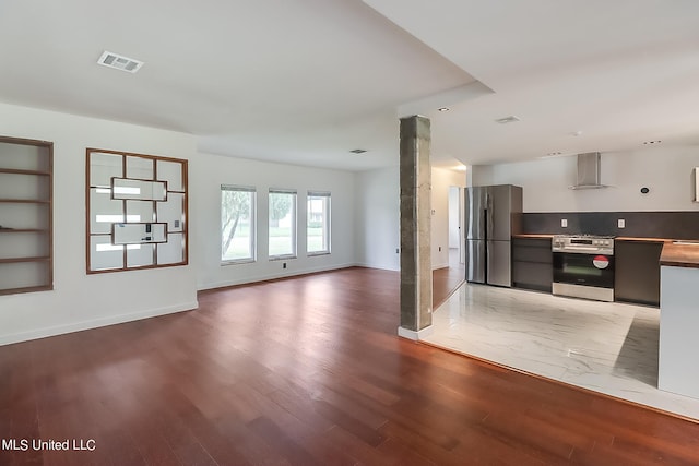 interior space featuring wood-type flooring and ornate columns