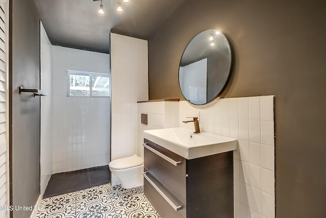 bathroom with vanity, tile walls, toilet, and tile patterned floors