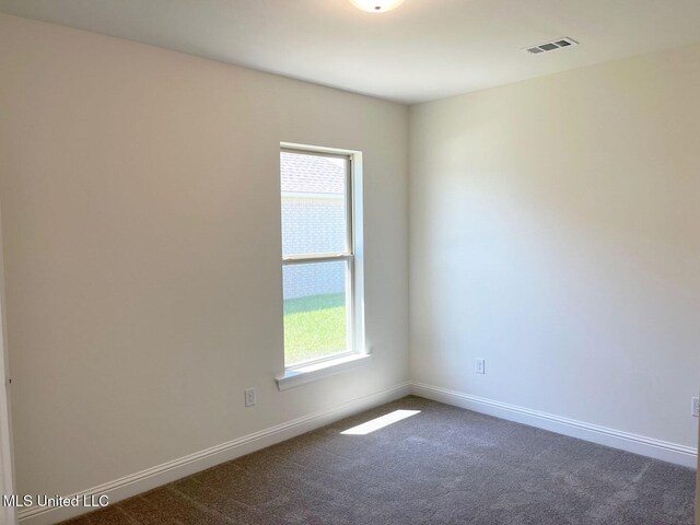 12111 Walker Rd, Ocean Springs, MS 39564 - unfurnished room with visible vents, baseboards, and dark carpet