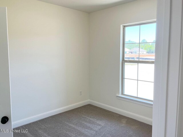 12111 Walker Rd, Ocean Springs, MS 39564 - spare room featuring dark colored carpet and baseboards