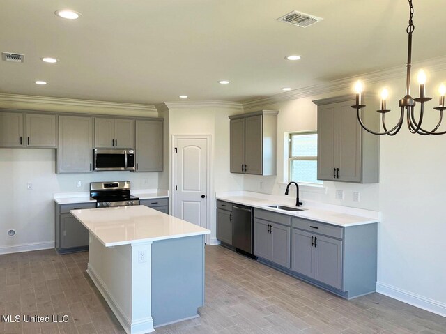 12111 Walker Rd, Ocean Springs, MS 39564 - kitchen featuring stainless steel appliances, visible vents, a sink, and gray cabinets
