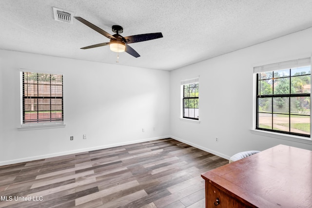 5423 Kaiki Dr, Diamondhead, MS 39525 - empty room featuring wood finished floors, ceiling fan, and a textured ceiling