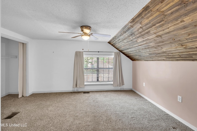 5423 Kaiki Dr, Diamondhead, MS 39525 - additional living space featuring a ceiling fan, carpet floors, vaulted ceiling, and a textured ceiling