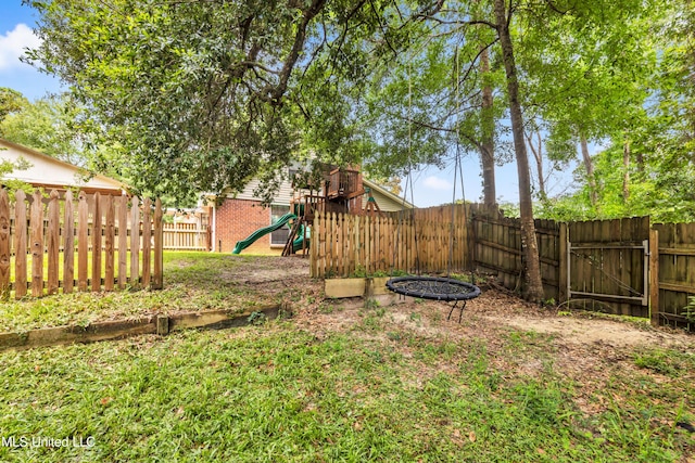 5423 Kaiki Dr, Diamondhead, MS 39525 - fenced backyard featuring a playground