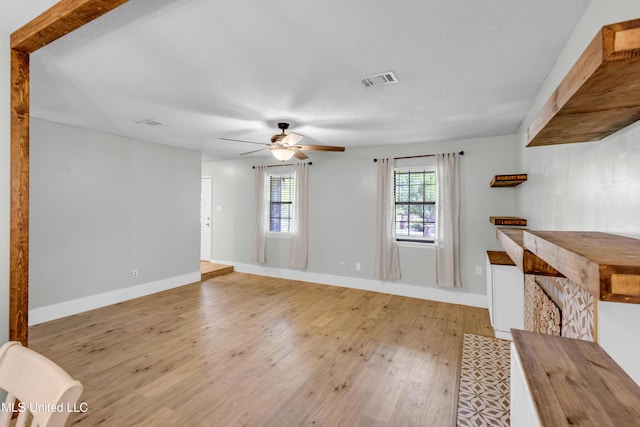 5423 Kaiki Dr, Diamondhead, MS 39525 - unfurnished living room with light wood-style floors and ceiling fan
