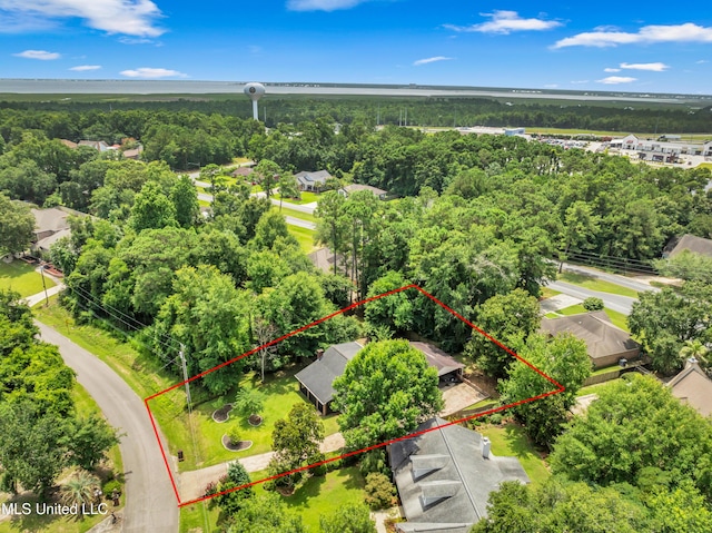 5423 Kaiki Dr, Diamondhead, MS 39525 - aerial view of property and surrounding area with property boundaries highlighted and a heavily wooded area