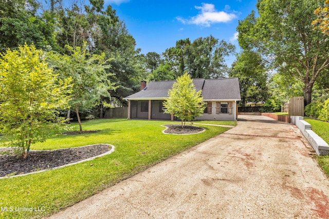 5423 Kaiki Dr, Diamondhead, MS 39525 - view of front facade featuring driveway and a chimney